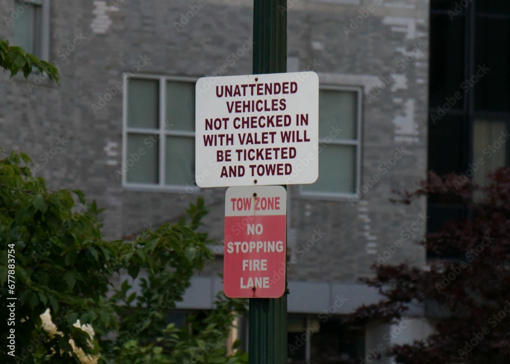 Closeup of a warning board on an iron pole with building blurred background Closeup of a warning board on an iron pole with building blurred background