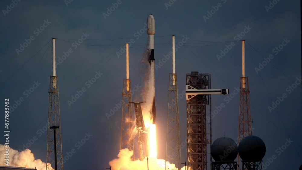 Spectacular shot of a Space Rocket blasting off from launch pad as it flies to space on its mission to place communication satellites in earth orbit. 4K. Slow-motion. Includes sound and audio.