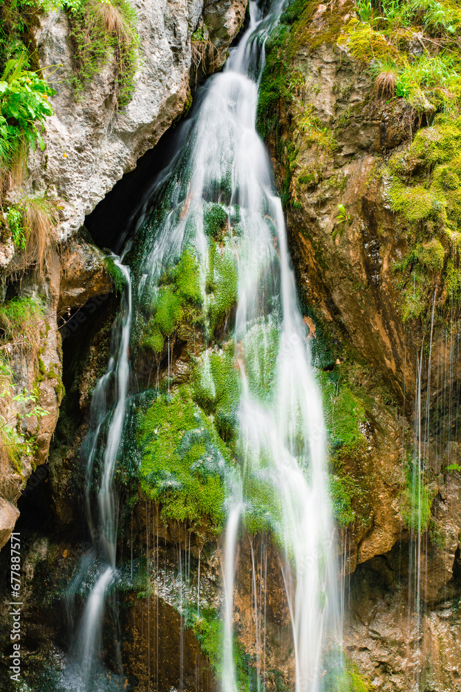waterfall with flowing water in the mountain