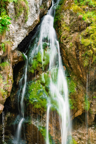 Obraz na płótnie waterfall with flowing water in the mountain w salonie