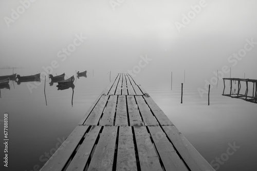 Obraz na płótnie fishing boats on the lake in the fog w salonie