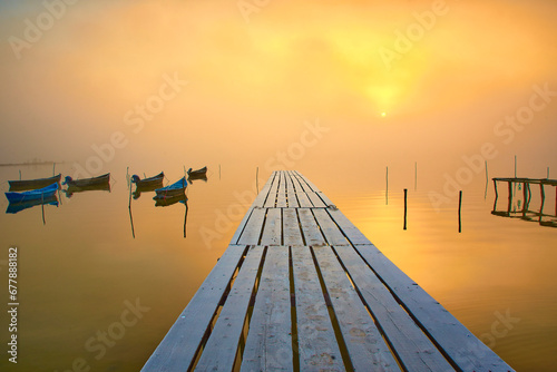 Obraz na płótnie fishing boats on the lake in the fog w salonie