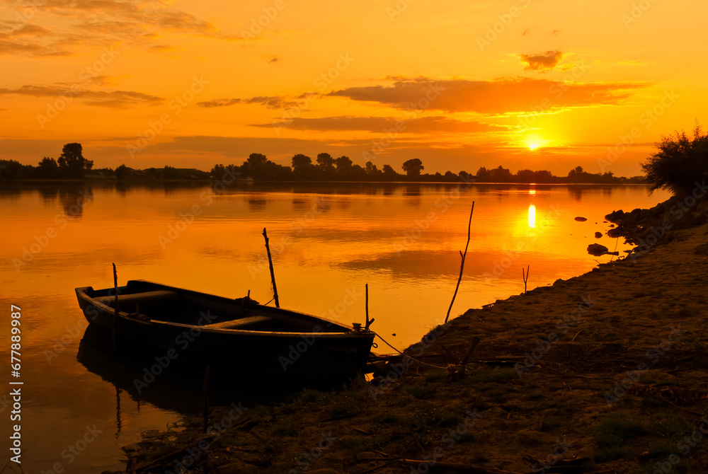sunrise with boats on the lake