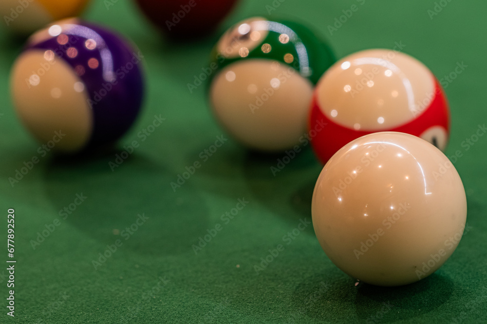 Colorful pool balls arranged on a billiard table, promising entertainment and friendly competition Colorful pool balls arranged on a billiard table, promising entertainment and friendly competition
