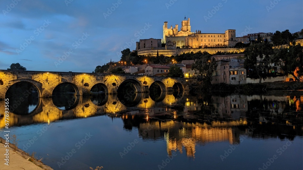 Scenic shot of Pont Vieux bridge in Beziers, France with the Cathedral of St. Nazarius on background
