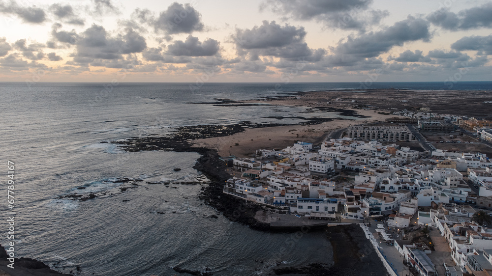 Panoramic view of El Cotillo bay, aerial high above point of view drone digital nomad night nightlife sunset sunrise dawn fuerteventura Spain