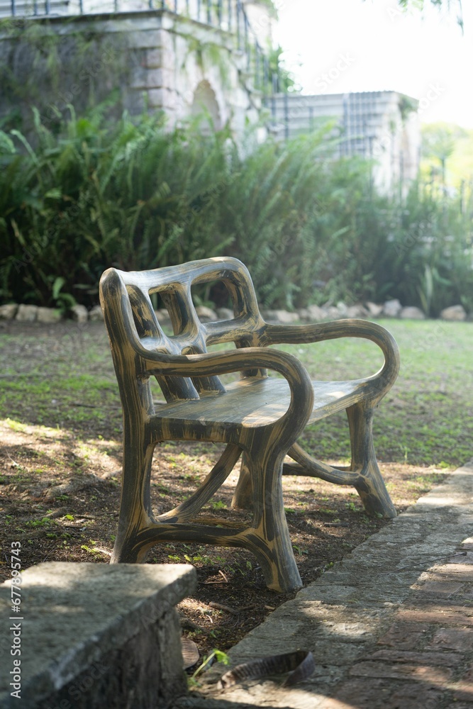 Vertical shot of a creative wooden bench in a park Vertical shot of a creative wooden bench in a park