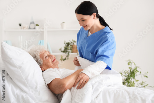 Female nurse putting senior...