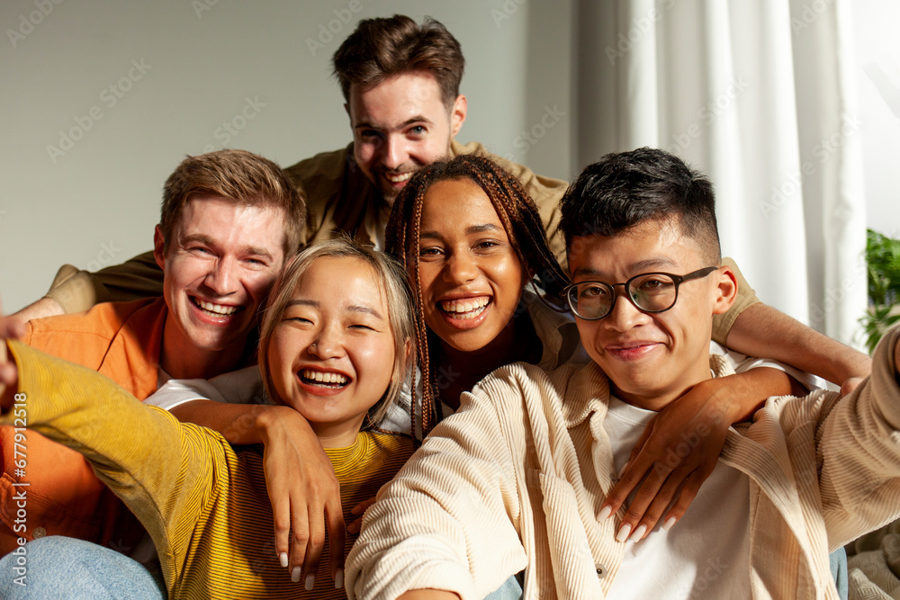 multiracial group of young friends smiling and taking selfies for the camera, asian, african american and european multiracial group of young friends smiling and taking selfies for the camera, asian, african american and european