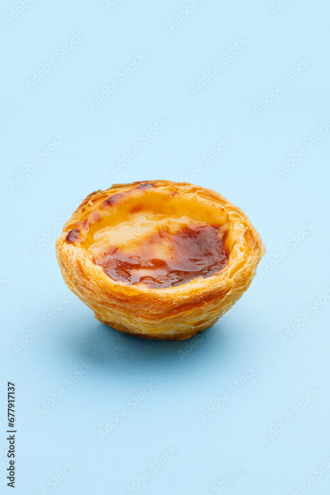 Traditional Portuguese egg tart dessert Pasteis Pastel de nata or Pasteis de Belem on blue background Traditional Portuguese egg tart dessert Pasteis Pastel de nata or Pasteis de Belem on blue background
