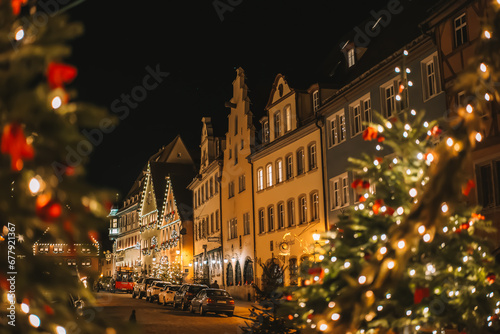 Rothenburg ob der Tauber.Christmas town background.Christmas in Europe. Christmas tree with balls and shining garlands. Christmas evening square with people walking. Soft focus. 