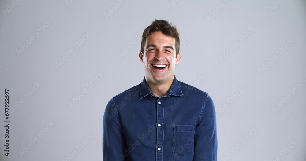 Man, face and laugh as comedy in studio grey background for crazy happy, joke meme or joy. Male person, model and portrait for emoji expression or silly goofy mood in playful, positive vibes or humor Man, face and laugh as comedy in studio grey background for crazy happy, joke meme or joy. Male person, model and portrait for emoji expression or silly goofy mood in playful, positive vibes or humor