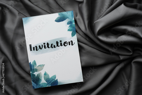 Beautiful card with word Invitation on black fabric, top view. Space for text