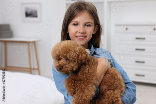 Little child with cute puppy at home. Lovely pet