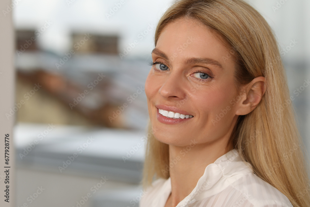 Portrait of confident entrepreneur or businesswoman, space for text. Beautiful lady with blonde hair smiling and looking into camera