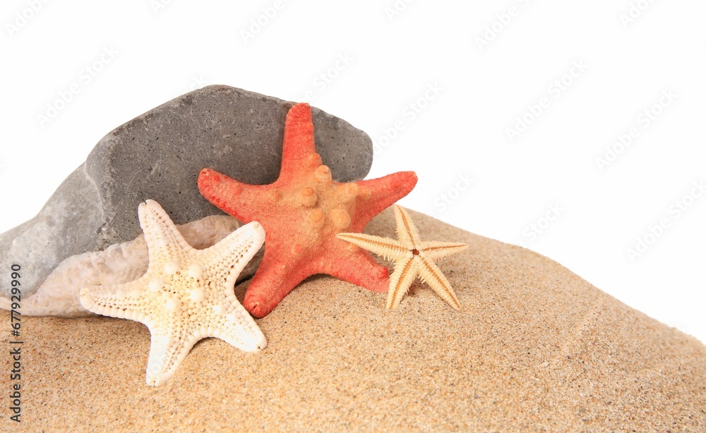 Sand with many beautiful sea stars and stone isolated on white, space for text Sand with many beautiful sea stars and stone isolated on white, space for text