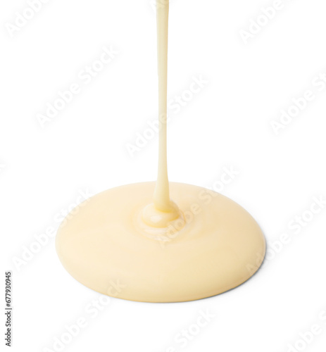 Pouring tasty condensed milk isolated on white