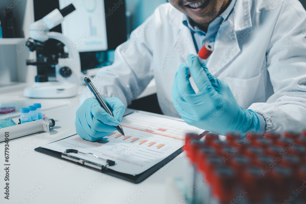 A chemist is using a microscope to search for chemicals from blood in a test tube, Chemist is chemically analyzing test tubes, Scientist is experimenting with chemicals in the laboratory,