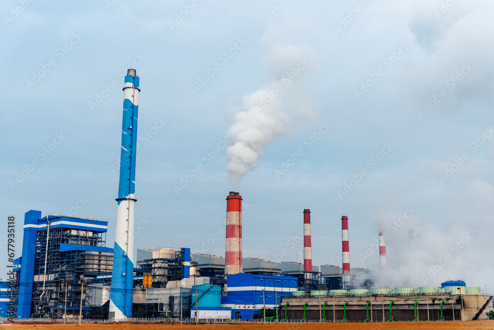 Power stations manufacturing electrical industrial plant. Electric power building refinery engineering smog steam smokestack. Lignite electricity chimneys release pollution in industry plant blue sky