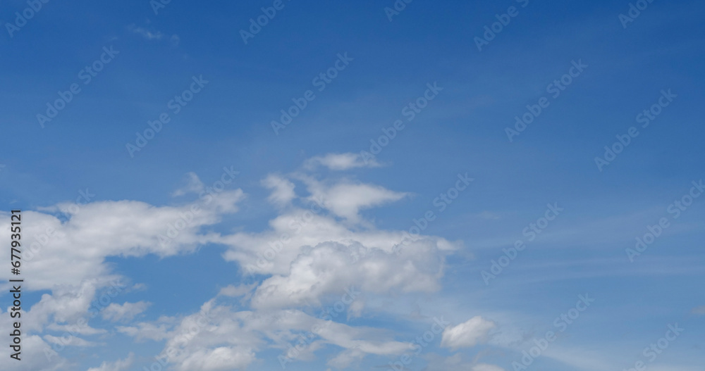 Blue sky fluffy white clouds on summer season bright clear skyline with beautiful cloudscape. Panorama blue sky clouds pattern on daylight with copy space. Cumulus cloudscape air climate sunny day Blue sky fluffy white clouds on summer season bright clear skyline with beautiful cloudscape. Panorama blue sky clouds pattern on daylight with copy space. Cumulus cloudscape air climate sunny day