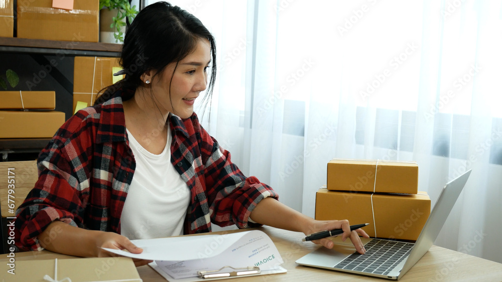 Online seller Close up hands Young asian woman typing laptop keyboard checking online order, check goods stock delivery package shipping postal. Asian woman startup small business at home office Online seller Close up hands Young asian woman typing laptop keyboard checking online order, check goods stock delivery package shipping postal. Asian woman startup small business at home office