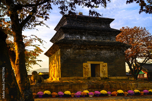 Gyeongju City landmark Bunhwangsa Buddhist Temple, 1,500 year old heritage preservation site, in South Korea, the oldest remaining stone tower with golden sun rays illuminating the walls at sunrise photo