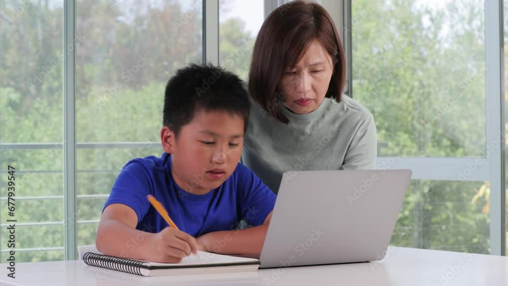 Mother helping her son with his homework. Mother helping her son with his homework.