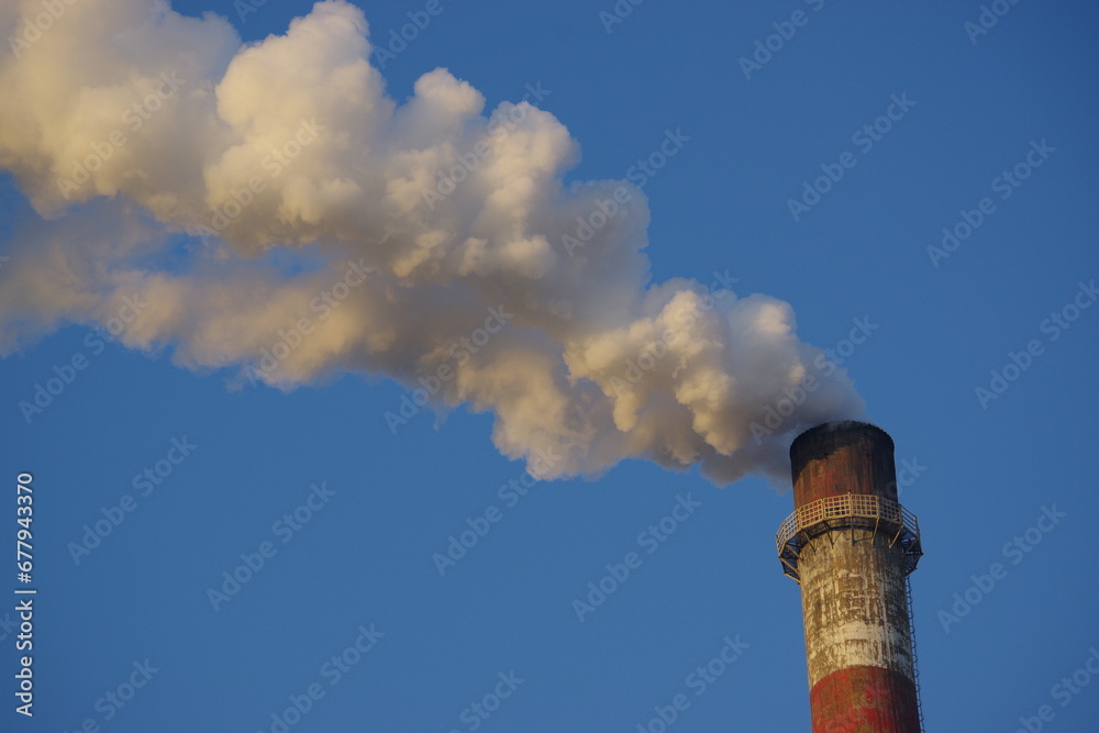 Chimneys blowing smoke on a background of blue sky Chimneys blowing smoke on a background of blue sky