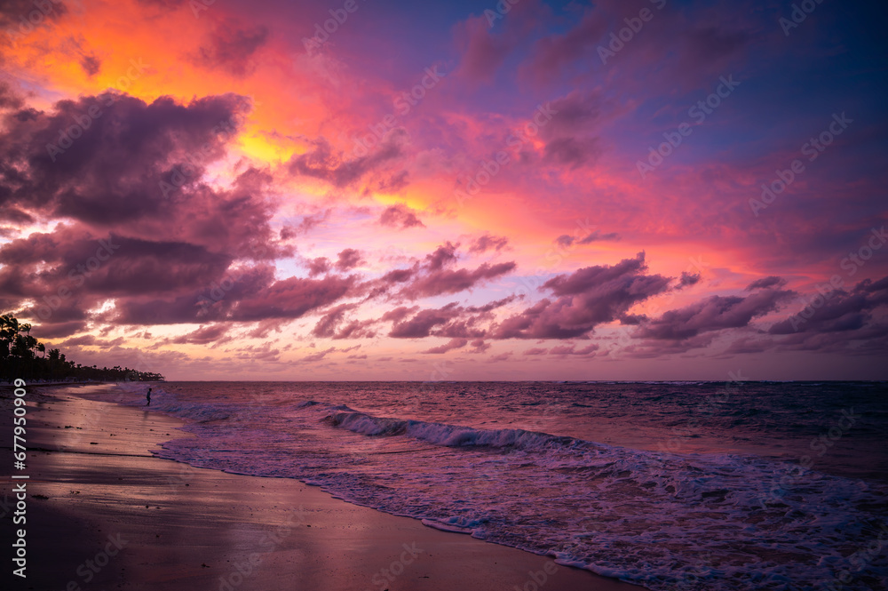 Sunset over Bavaro Beach and the Atlantic ocean, dramatic and colourful sunset dusk sky, waves hitting coast, Punta Cana, Dominican Republic, Caribbean. Photo taken in April 2022.