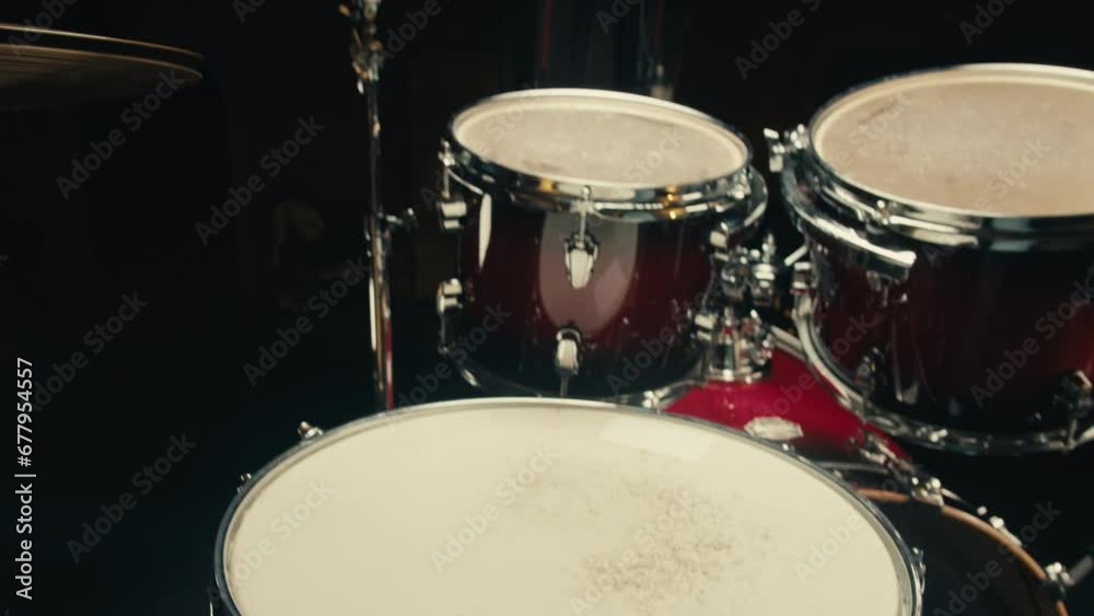 Expressive drummer young man professionally playing on dums in studio room close-up. Rock metall music artist 