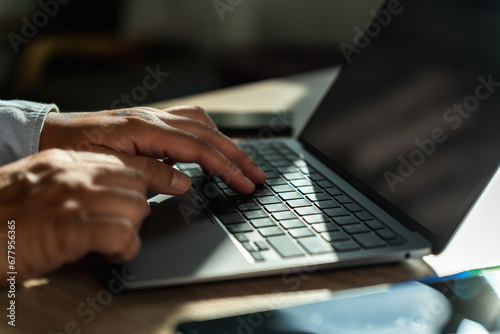 man using a laptop typing, searching, web browsing, online on a computer Search engine optimization SEO technology connection job search