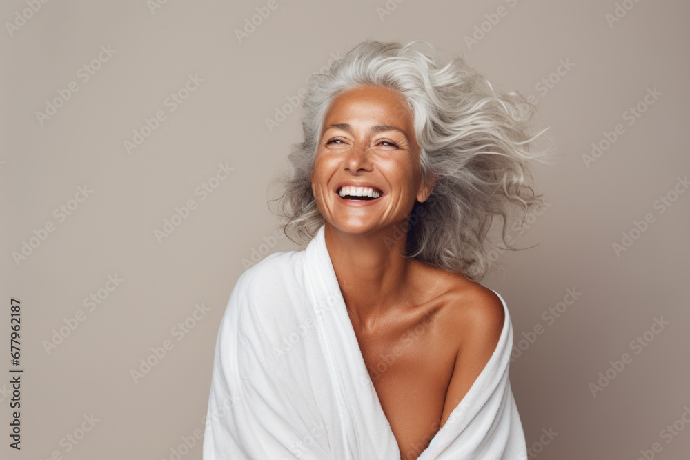 portrait of happy smiling beautiful senior woman wearing towel
