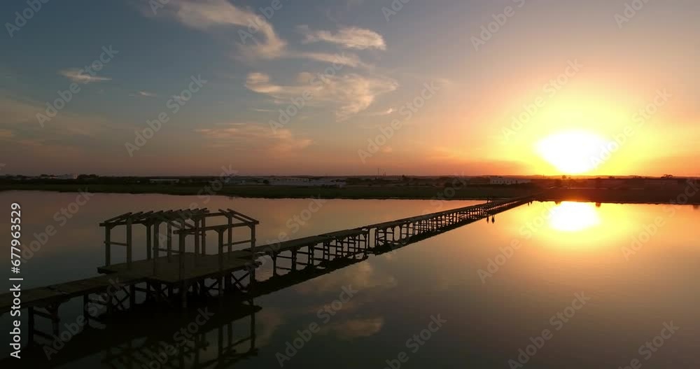 Aerial: Drone Panning Shot Of Damaged Wooden Pier At Sunset, Drone Flying Over Tranquil Lake - Mahdia, Tunisia Aerial: Drone Panning Shot Of Damaged Wooden Pier At Sunset, Drone Flying Over Tranquil Lake - Mahdia, Tunisia