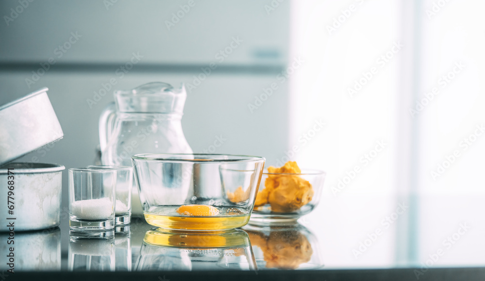 Fresh ingredients in glass bowl preapare baking cake place on kitchen table Fresh ingredients in glass bowl preapare baking cake place on kitchen table