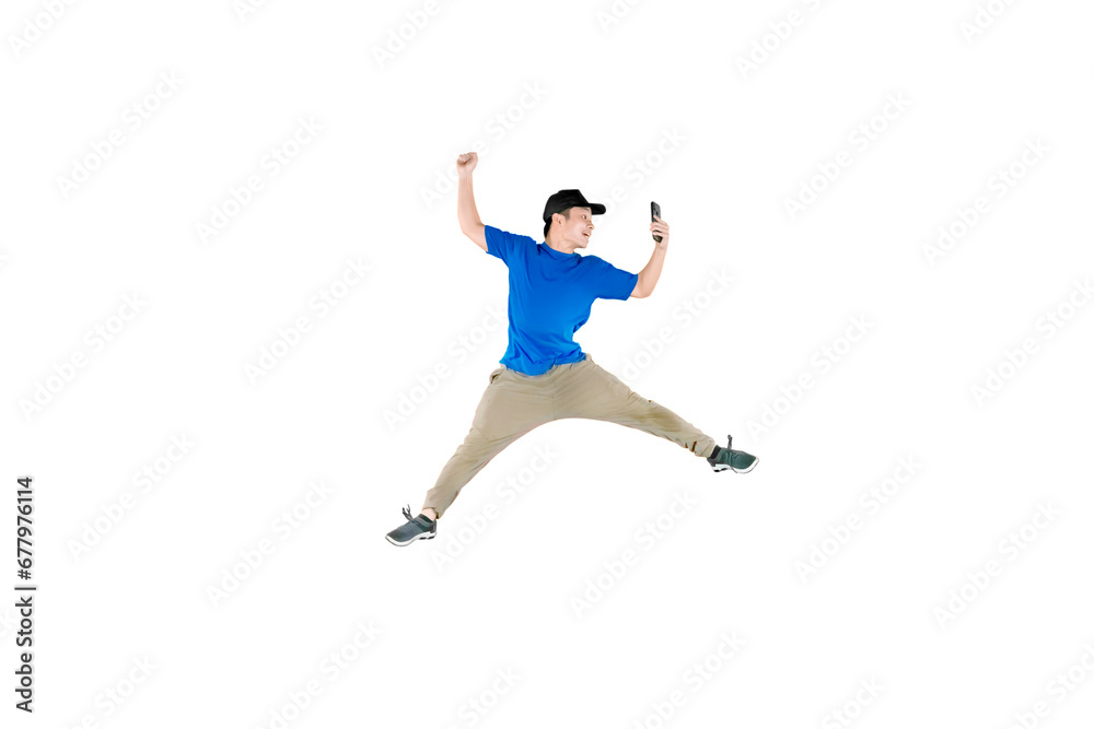Young guy wearing hat looking at his mobile phone while doing some acrobatic moves