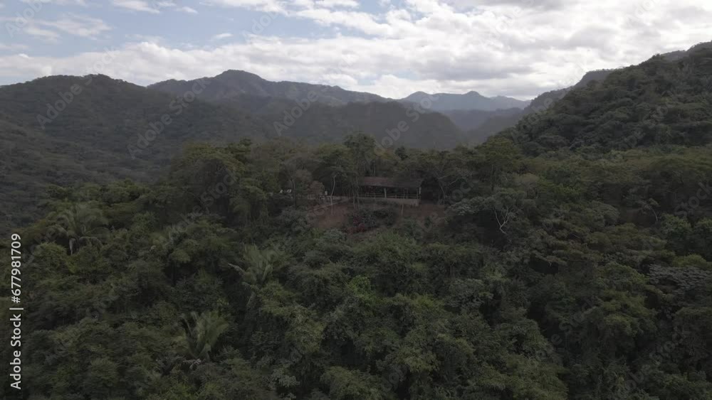 A serene drone pullout unveils a cozy shack nestled within the serene Sierra Madre mountain range in Jalisco, Mexico A serene drone pullout unveils a cozy shack nestled within the serene Sierra Madre mountain range in Jalisco, Mexico