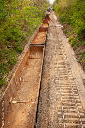 Above view of empty train cars on tracks in a rural setting 