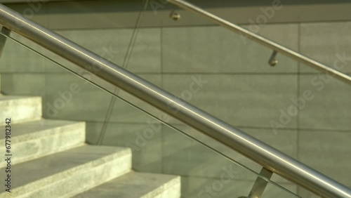 Close-up of stainless steel handrails with glass panels, modern stairway design elements. photo