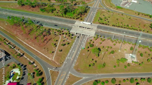 Beautiful aerial of logistics business  in action, Semi tractors and trailers driving. Jasper, Florida photo