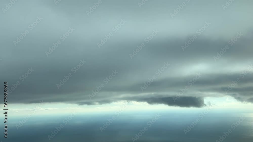 Flying under a dramatic sky covered with stormy clouds over the sea. A pilot’s perspective. 7000m high. Flying under a dramatic sky covered with stormy clouds over the sea. A pilot’s perspective. 7000m high.