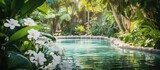 In the tranquil spa garden surrounded by lush green plants and tropical trees the background is adorned with delicate white floral blooms creating a serene oasis of beauty in the midst of n