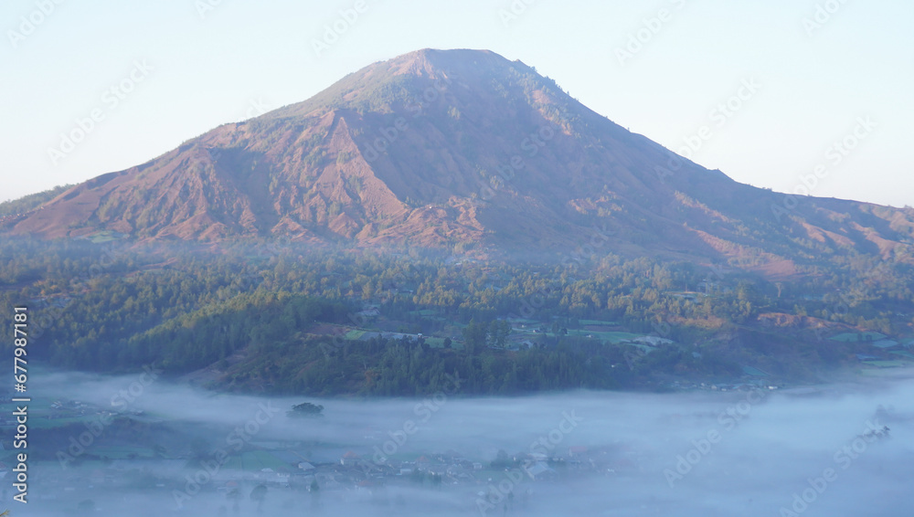 Closeup of Mount Batur morning view with fog from Pinggan Village or Desa Pinggan in Indonesia with fog. Kintamani, Bali, Indonesia