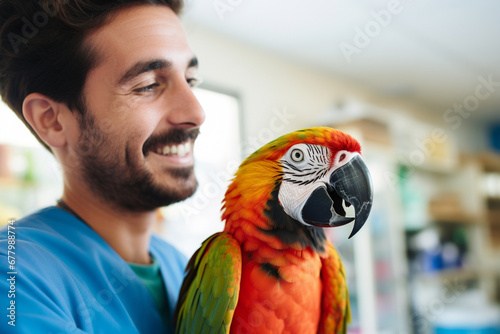 a male excotic pet vet smiling to a parrot bokeh style background
