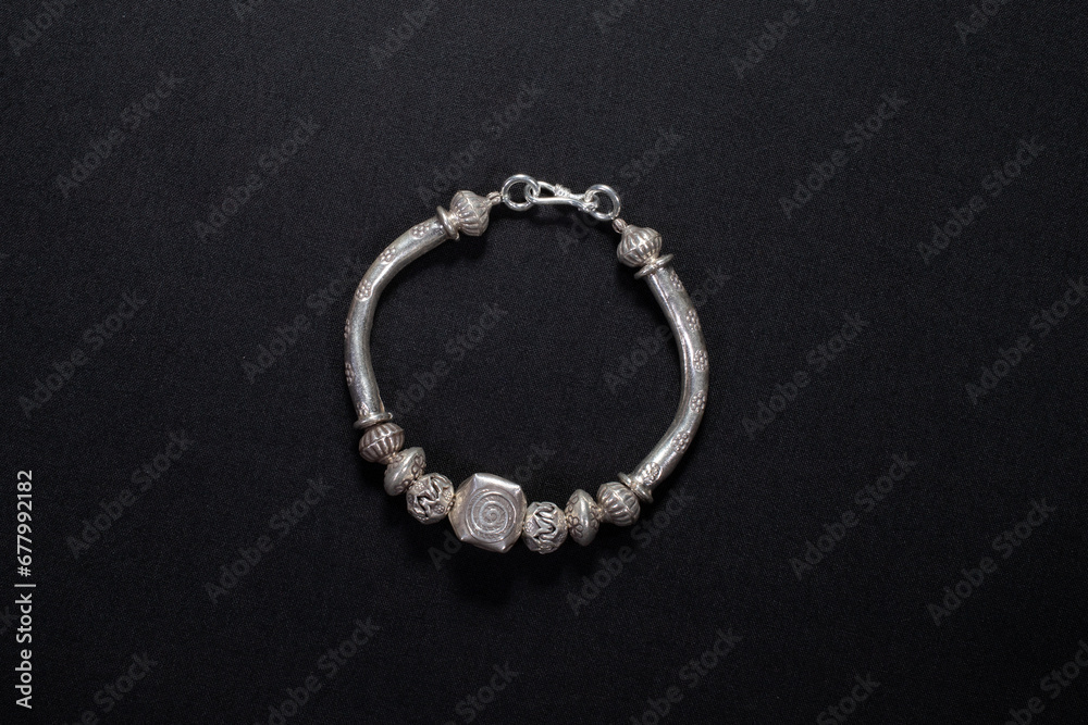 Hmong silver jewelry on black background, Handmade silver accessories Hmong silver jewelry on black background, Handmade silver accessories