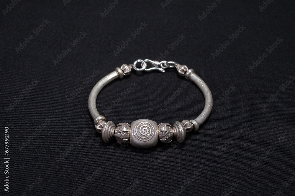Hmong silver jewelry on black background, Handmade silver accessories Hmong silver jewelry on black background, Handmade silver accessories