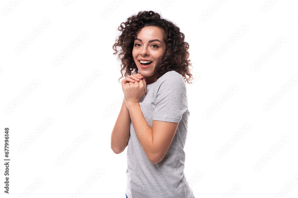 young brunette promoter woman dressed in a gray t-shirt on a white background with copy space young brunette promoter woman dressed in a gray t-shirt on a white background with copy space