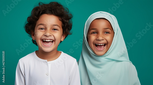 Portrait of joyful arabian kids on isolated solid green background photo