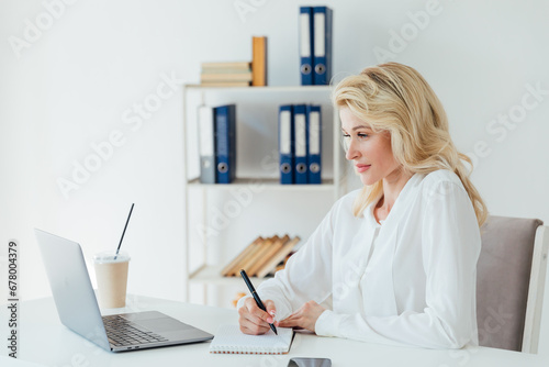 woman secretary working with laptop computer in office