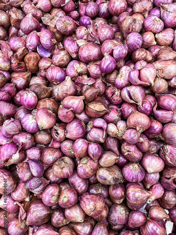 Red Onions are nicely stacked and piled up on this little market