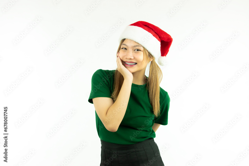 Happy asian girl wears a christmas red santa claus hat isolated on white background Happy asian girl wears a christmas red santa claus hat isolated on white background